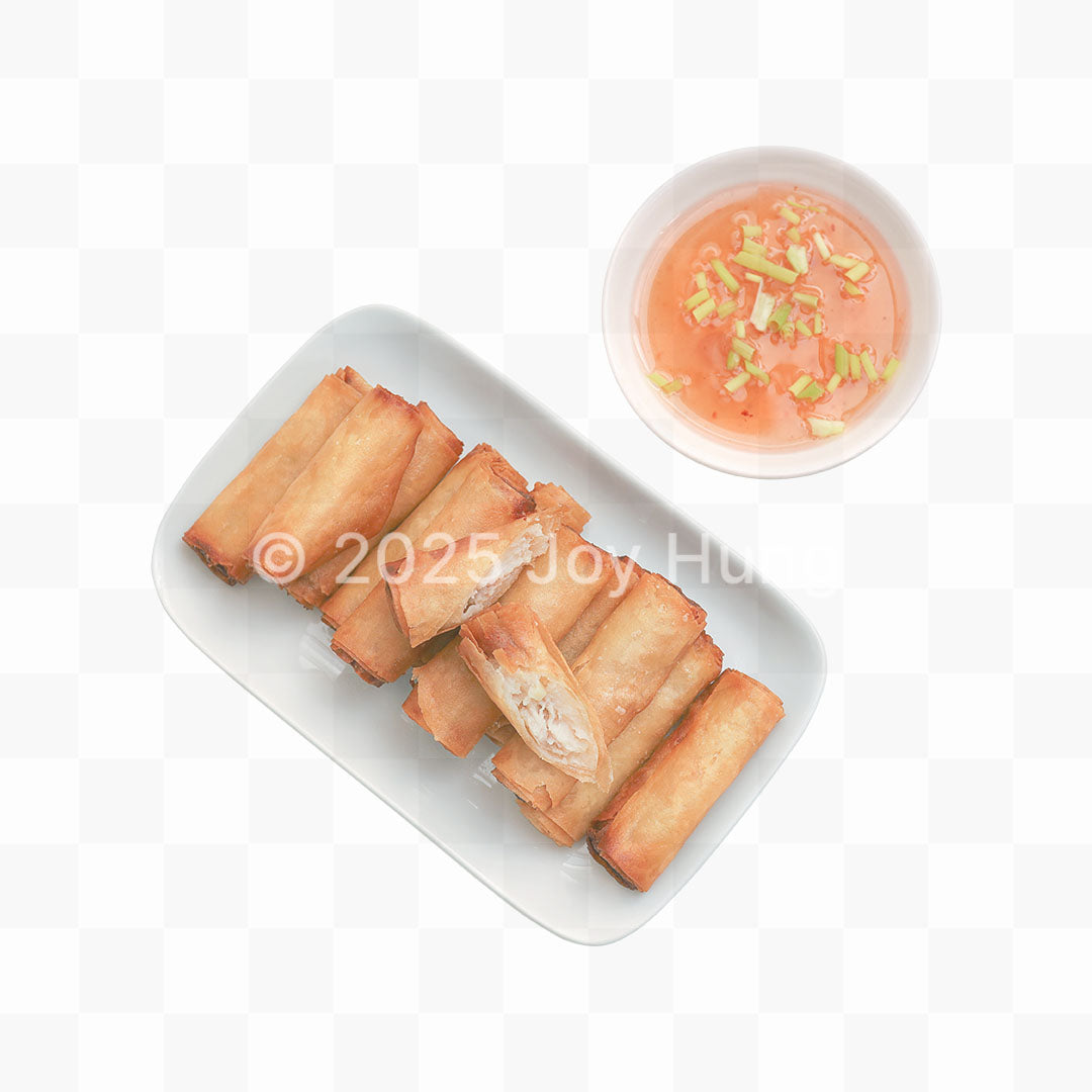 Spring rolls on a white plate with a side of dipping sauce on a white background