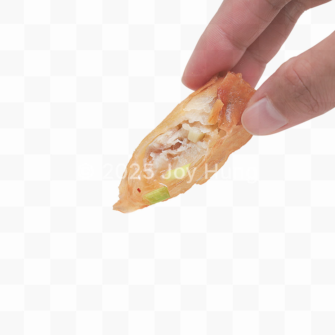 Hand holding a half-eaten lumpia with visible filling on a white background