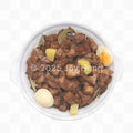 Stewed meat dish with potatoes and eggs in a white bowl on a white background