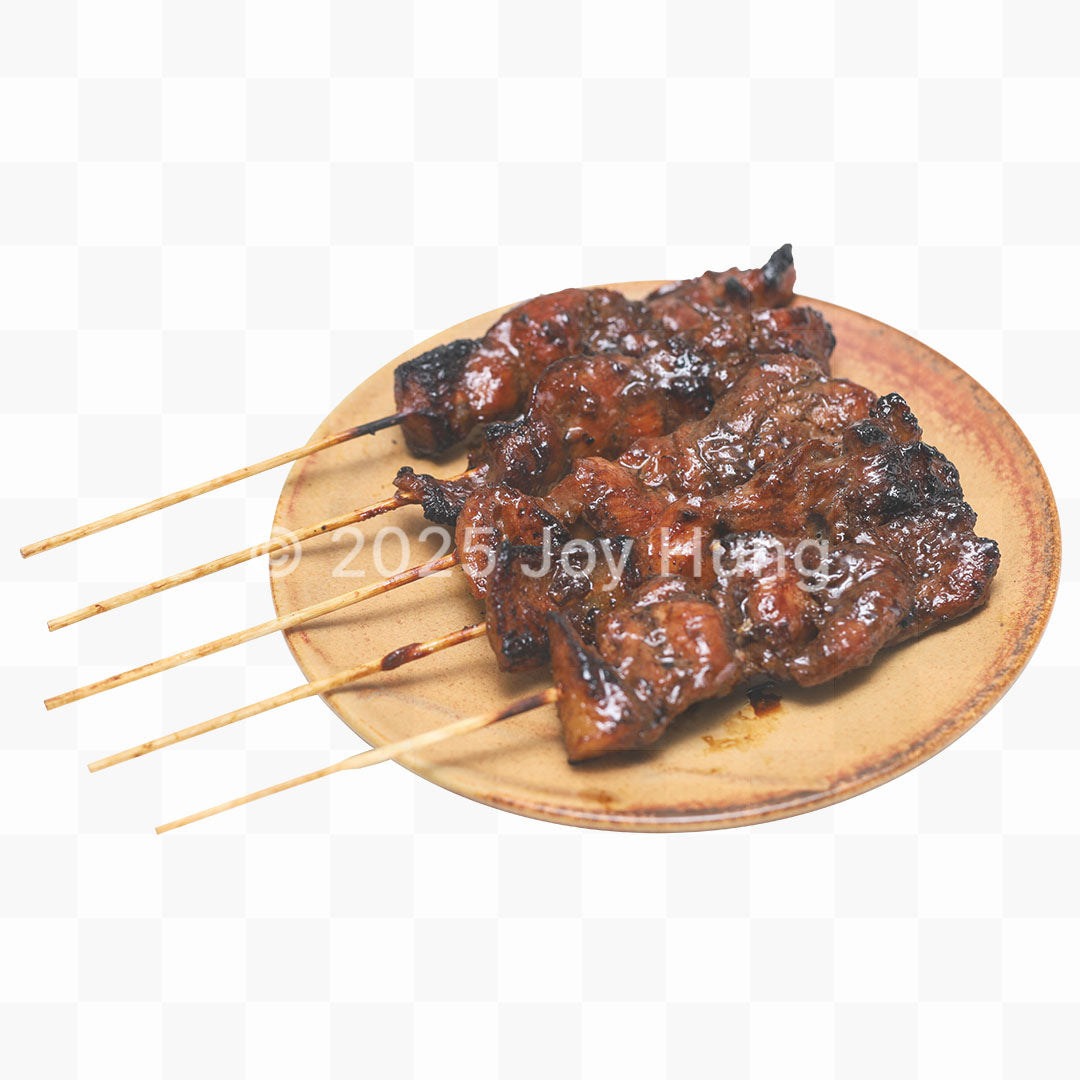 Grilled skewers on a wooden plate with a white background