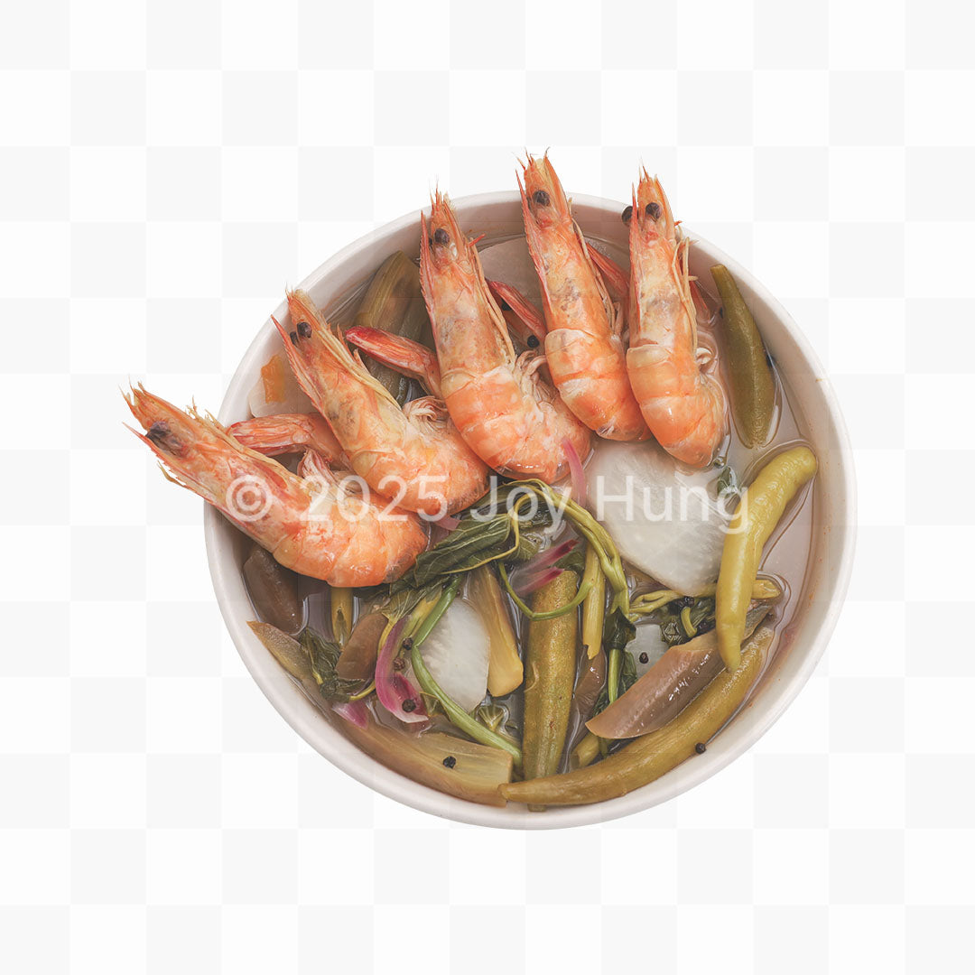 Bowl of sinigang with shrimp and vegetables on a white background