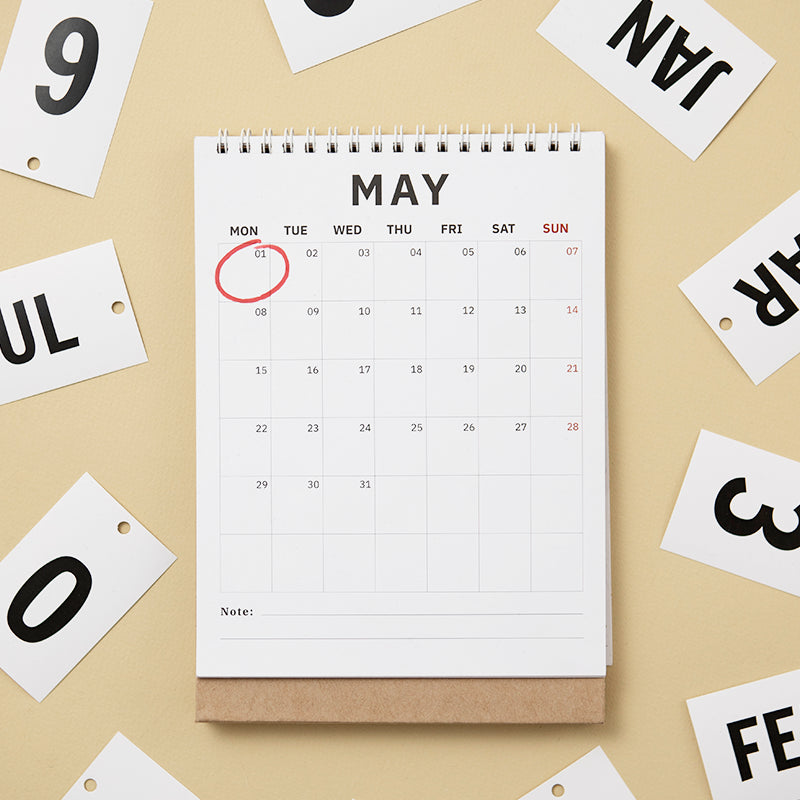 Calendar for May on a beige background with scattered letters