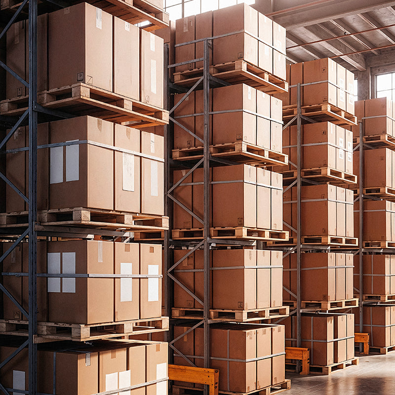 Stacks of cardboard boxes on pallets in a warehouse.